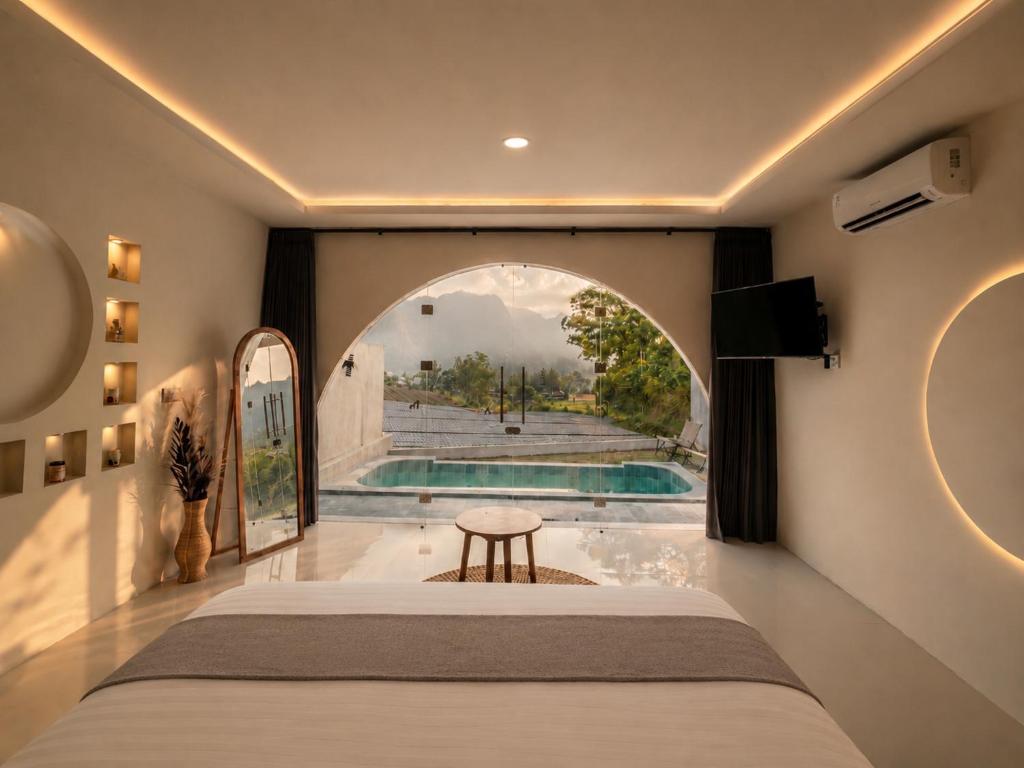 a bedroom with a bed and a swimming pool at Montelago Batur in Bangli