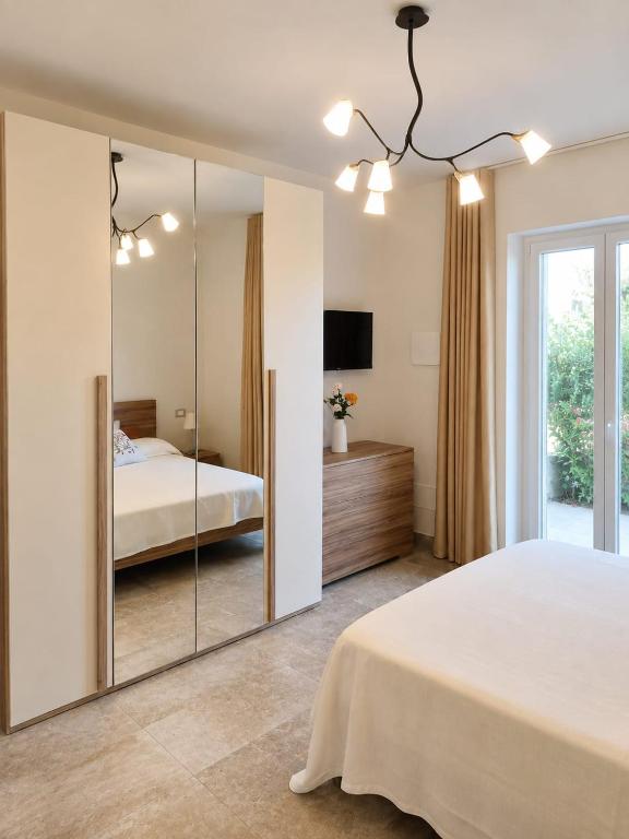 a bedroom with a large mirror and a bed at B&B da Cencia in Monte San Biagio