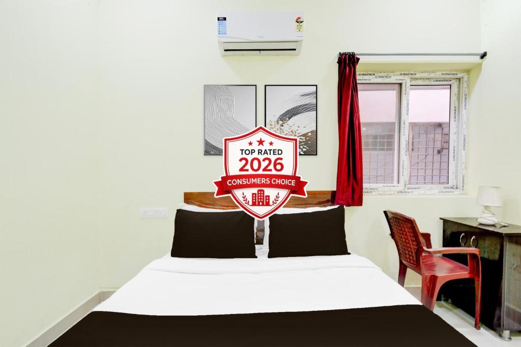 a bedroom with a bed with a sign on it at Super Hotel O Moula Ali Neredmet in Hyderabad