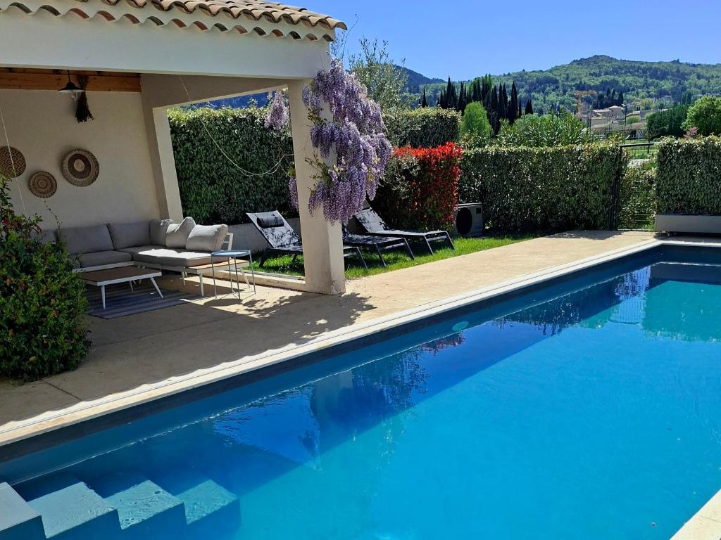 a swimming pool in front of a house at Onze Villa in Provence, Mont Ventoux, New Luxury Villa, Private Pool, Stunning views, Outdoor Kitchen, Big Green Egg in Malaucène