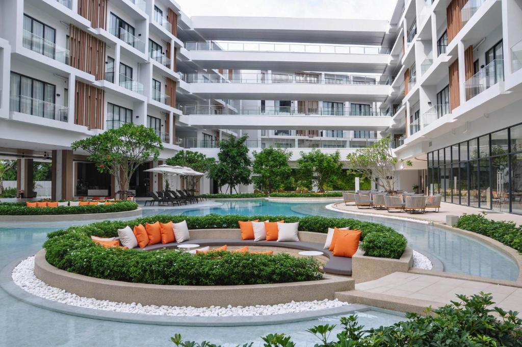 an exterior view of a building with a pool at Radisson Resort Layan Phuket in Layan Beach