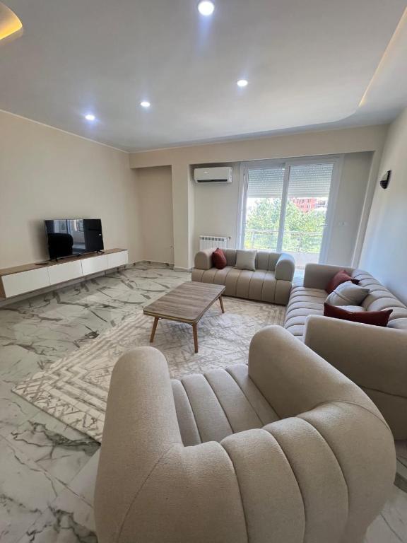 a living room with a couch and a table at luxury apartment in Annaba