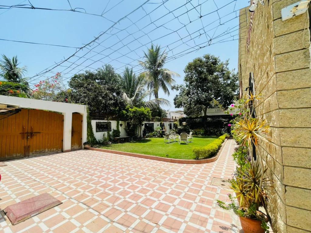 a house with a brick patio and a yard at Signature 3 Bed Villa Clifton Boat Basin in Karachi
