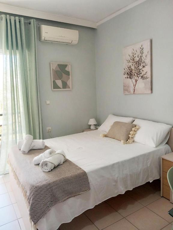 a bedroom with a bed with towels on it at Studio Nicki Chania in Chania