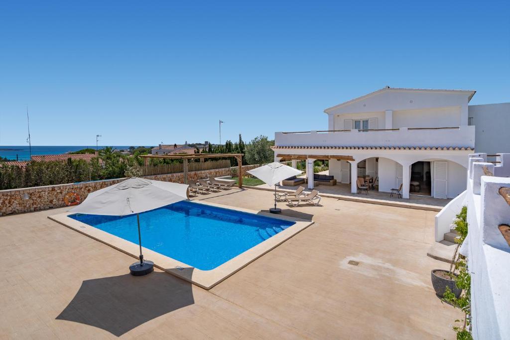 a villa with a swimming pool and a house at VILLA JESSELLA in Punta Prima