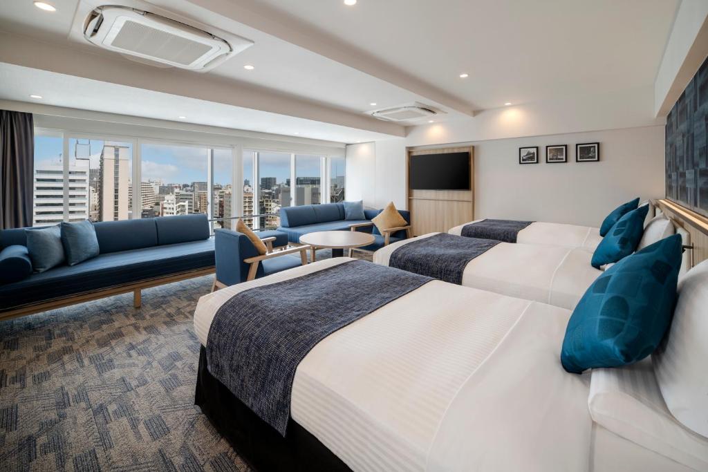 a hotel room with two beds and a couch at HOTEL MYSTAYS Nagoya Sakae -Renewed in September 2026 All Guest Rooms & Breakfast in Nagoya