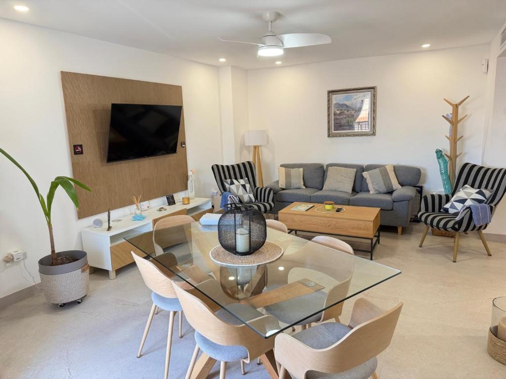a living room with a couch and a table and chairs at Cabosun in El Cabo de Gata