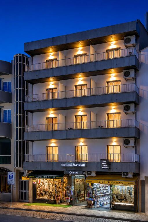 a building with a store in front of it at Residência São Francisco by Umbral in Fátima