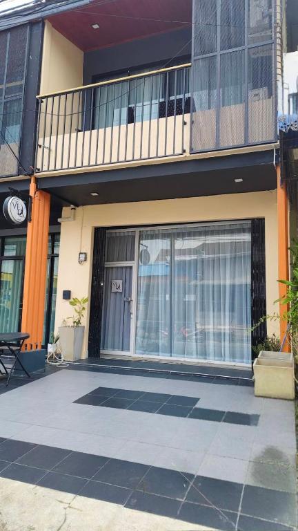 a building with a large window and a balcony at Vela House Hatyai in Hat Yai