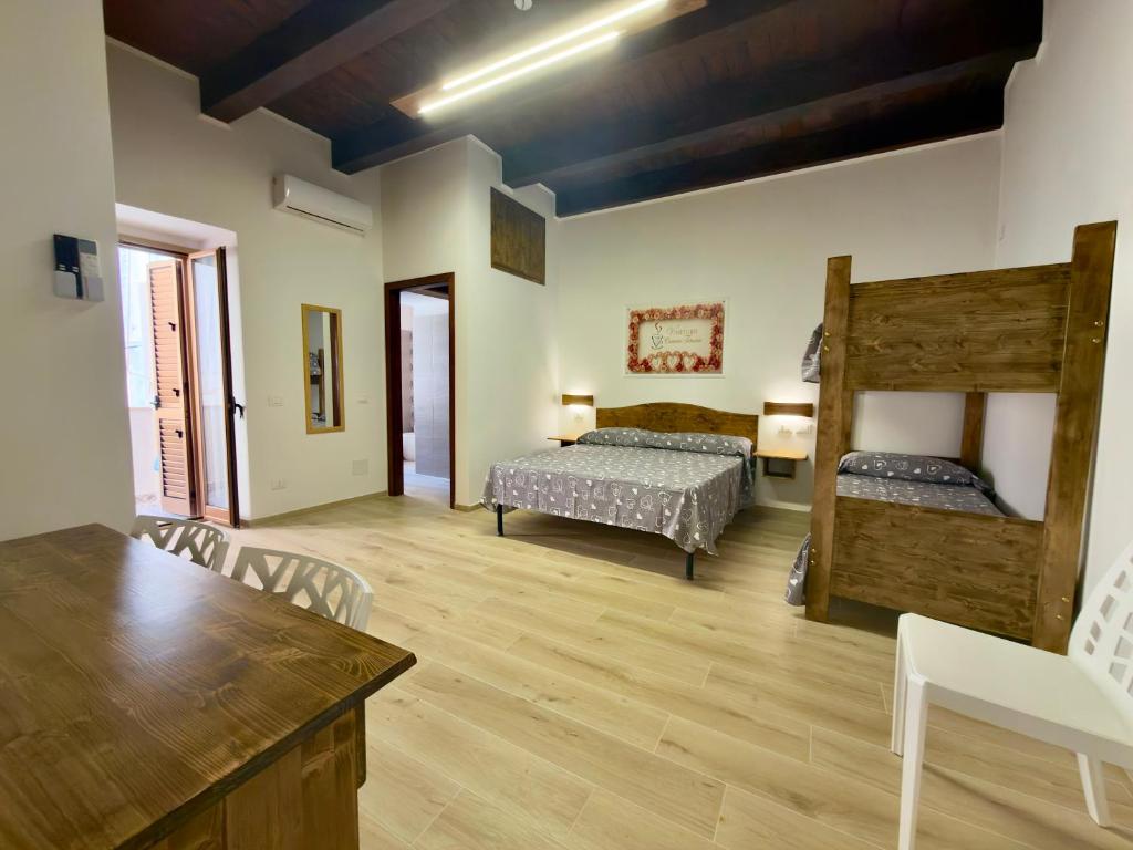 a bedroom with two bunk beds and a table at Vin e Turn in Diamante
