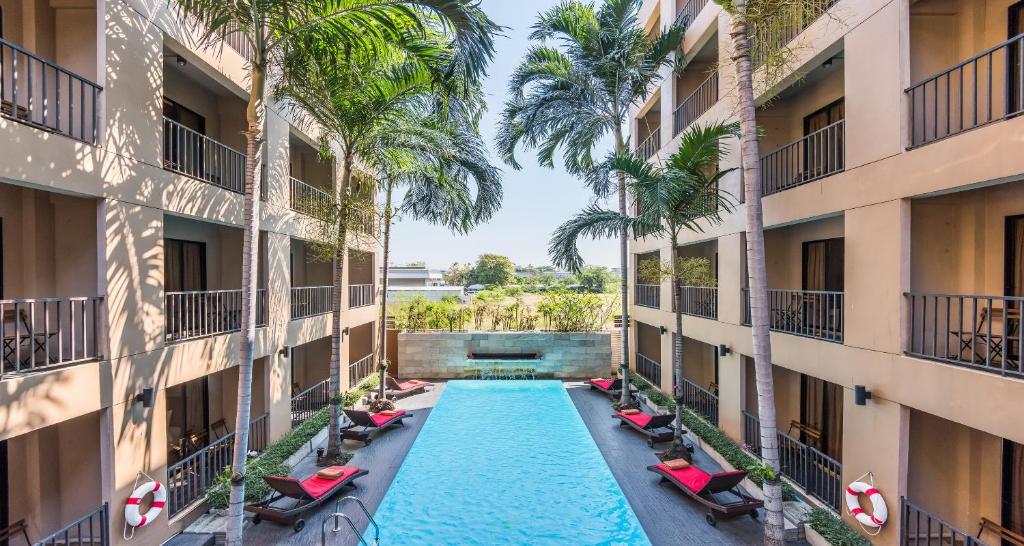 a view of a swimming pool between two buildings at The Cottage Suvarnabhumi in Lat Krabang