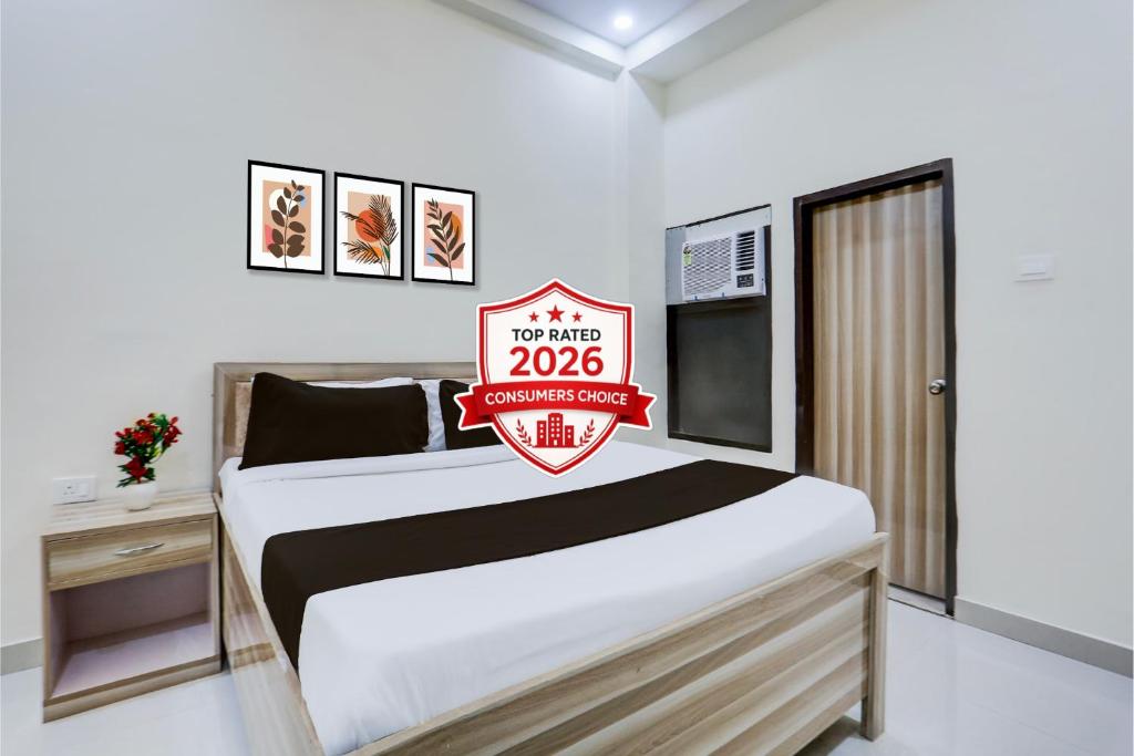 a bedroom with a bed with a sign on it at OYO Collection O Kalyanpur Metro Station in Kaliānpur