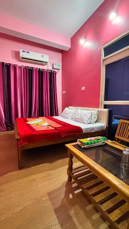 a room with a bed and a table in it at Hotel Ashirwad in Chhatarpur