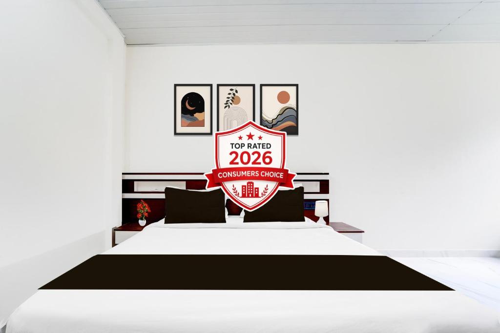 a bedroom with a bed with a sign on it at Super Hotel O North Kalamassery in Cochin