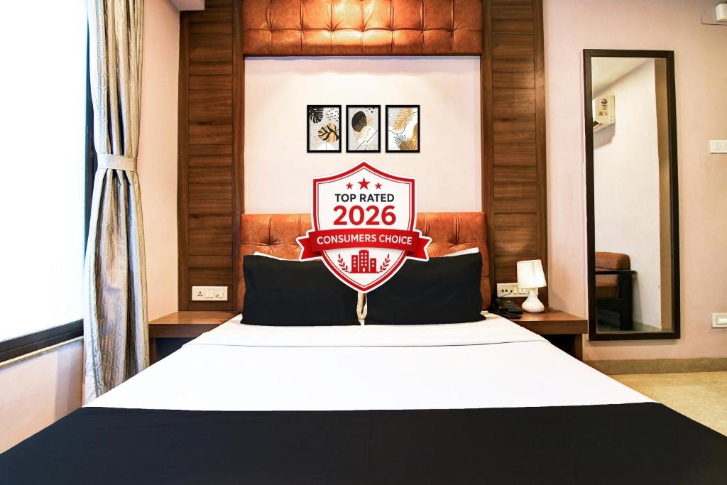 a hotel room with a bed with a sign on it at Super Hotel O Tagore Park Laskarhat Formerly Shankar Guest House in Kolkata