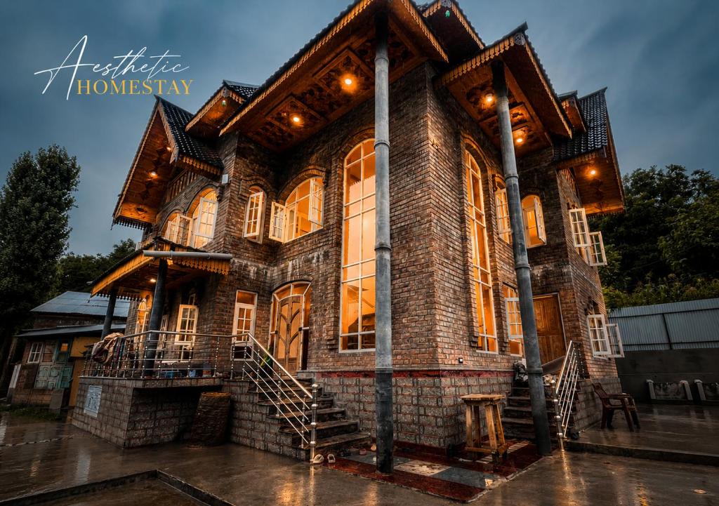 a large brick house with lights on at Aesthetic Homestay in Harganyiwan