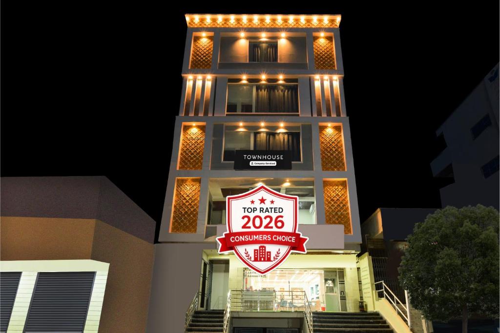 a tall building with a sign in front of it at Super Townhouse Badangpet Crossway Hyderabad Formerly Balapur in Surūrnagar