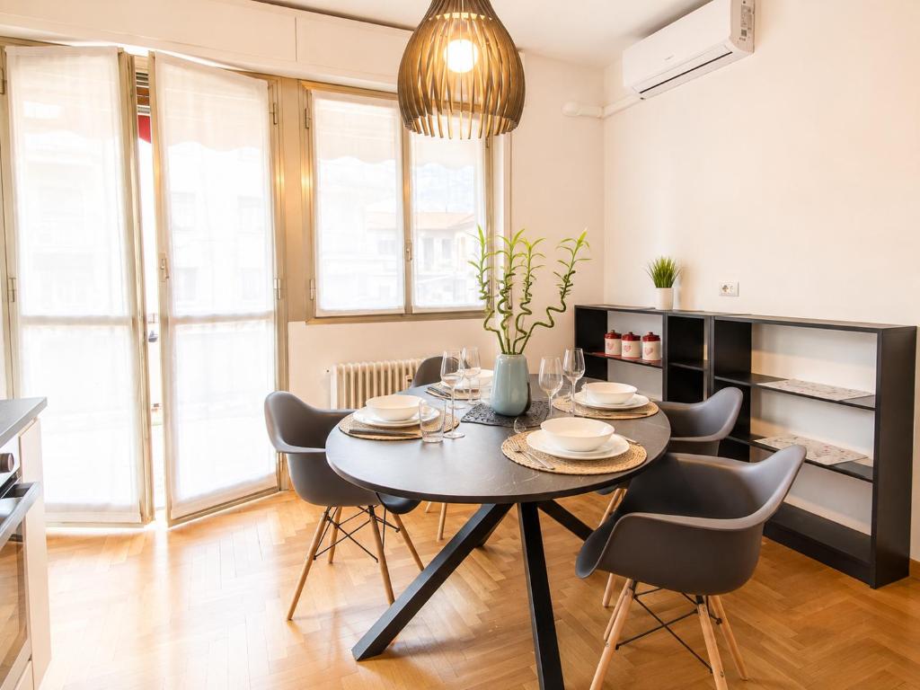a dining room with a table and chairs at The Charme - Modern Apartment in Como with Balcony in Como