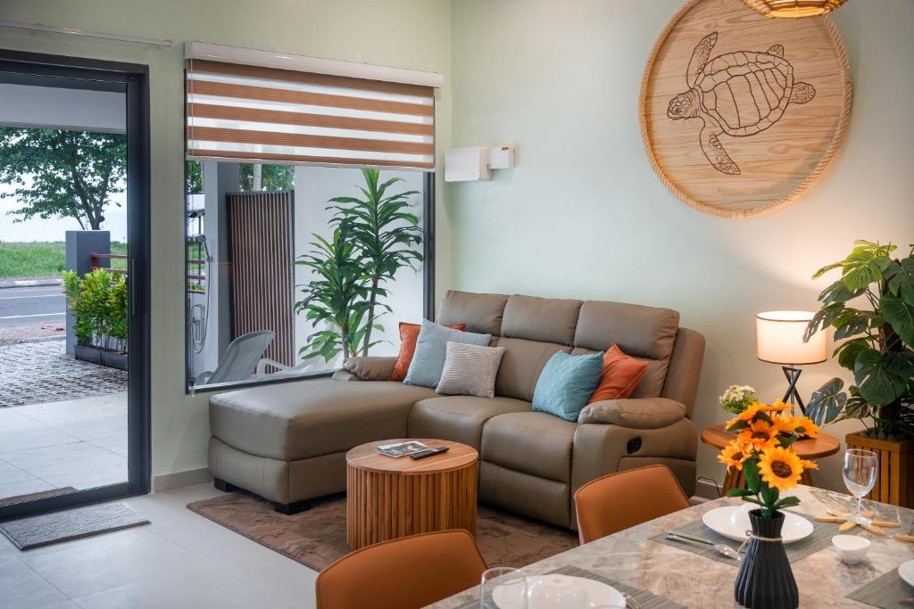 a living room with a couch and a table at Turtle Tales - Tao Yaa in Thai Muang