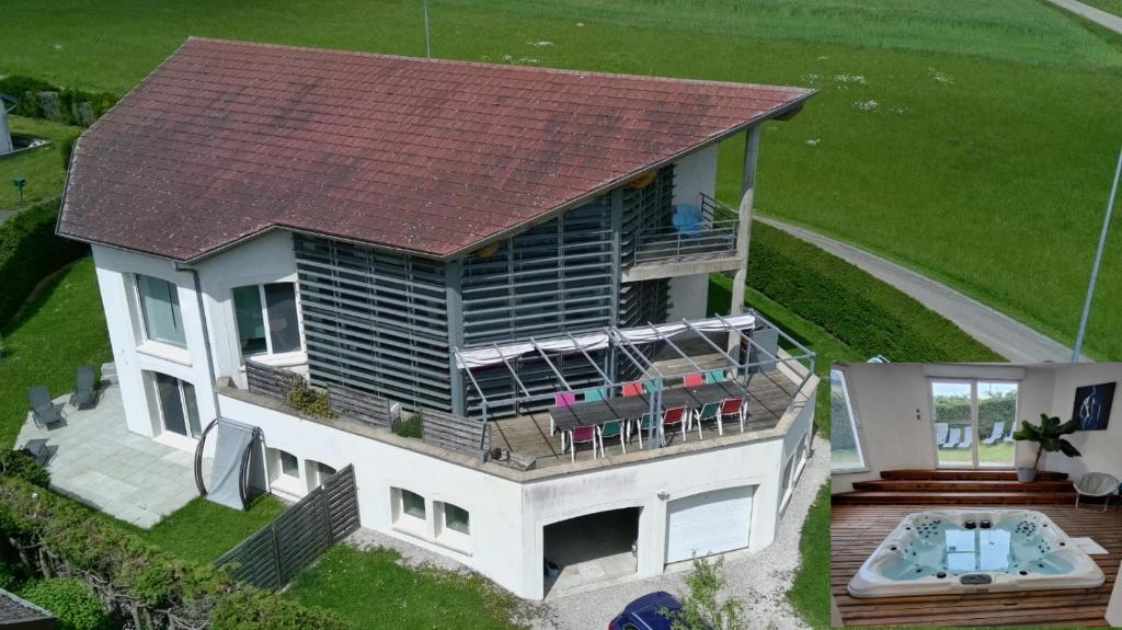 an aerial view of a house with a deck and a pool at L'Aquarium Attigneville in Attignéville