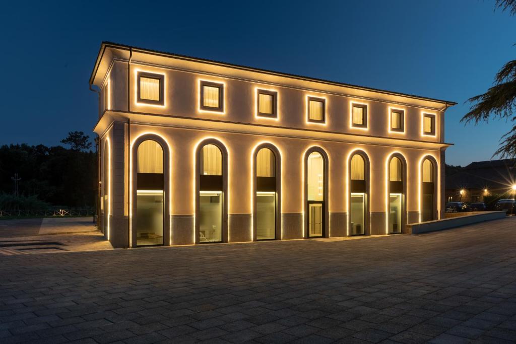 a building with lights on it at night at Best Western Plus Carolus Park Hotel in Sutri