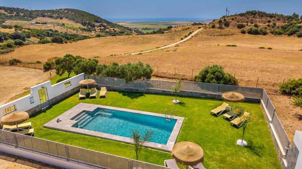 an overhead view of a swimming pool in a yard with grass at Loft luxury Mirador in Cádiz
