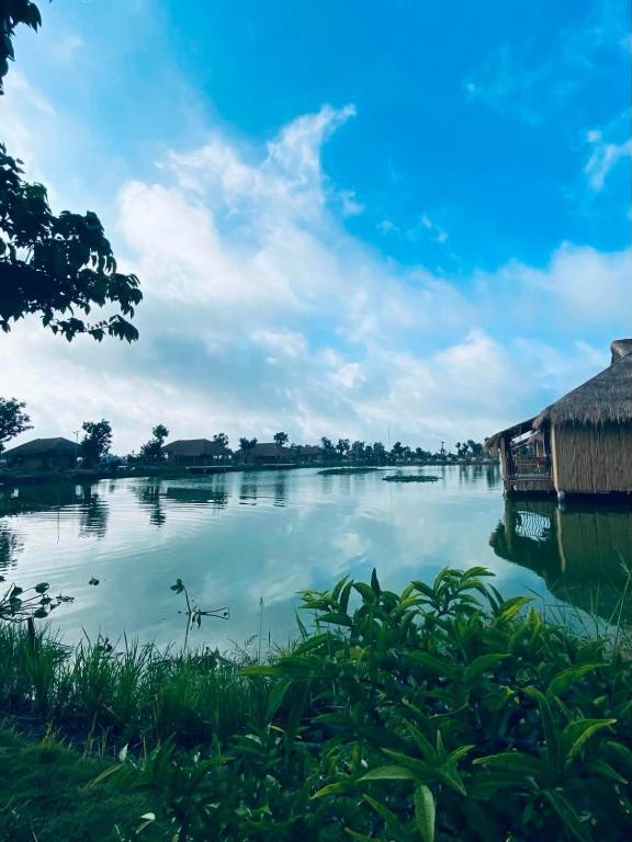a view of a river with a house on it at Dung Hoa Resort 