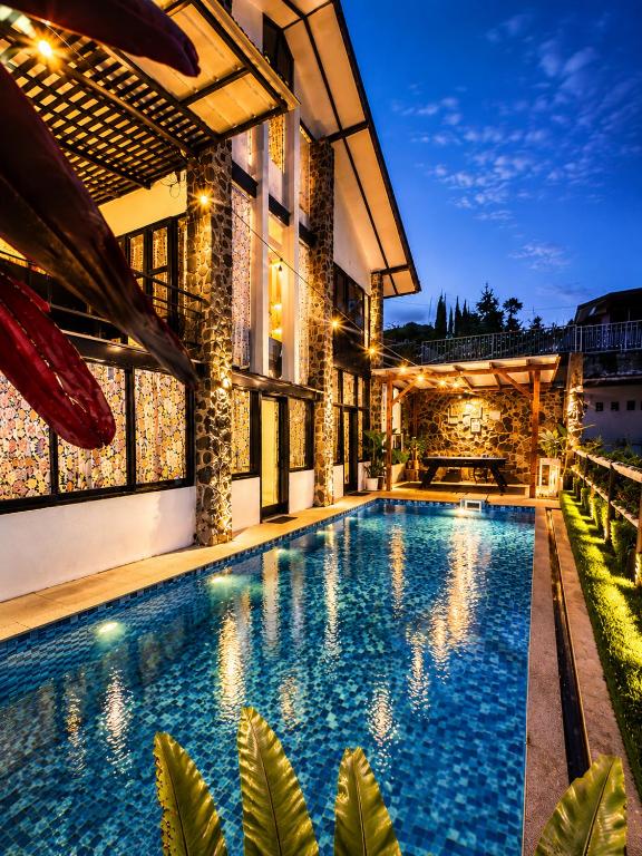 a swimming pool in front of a house at night at Villa W-5 Villa Private Pool Lembang, Bandung in Bandung
