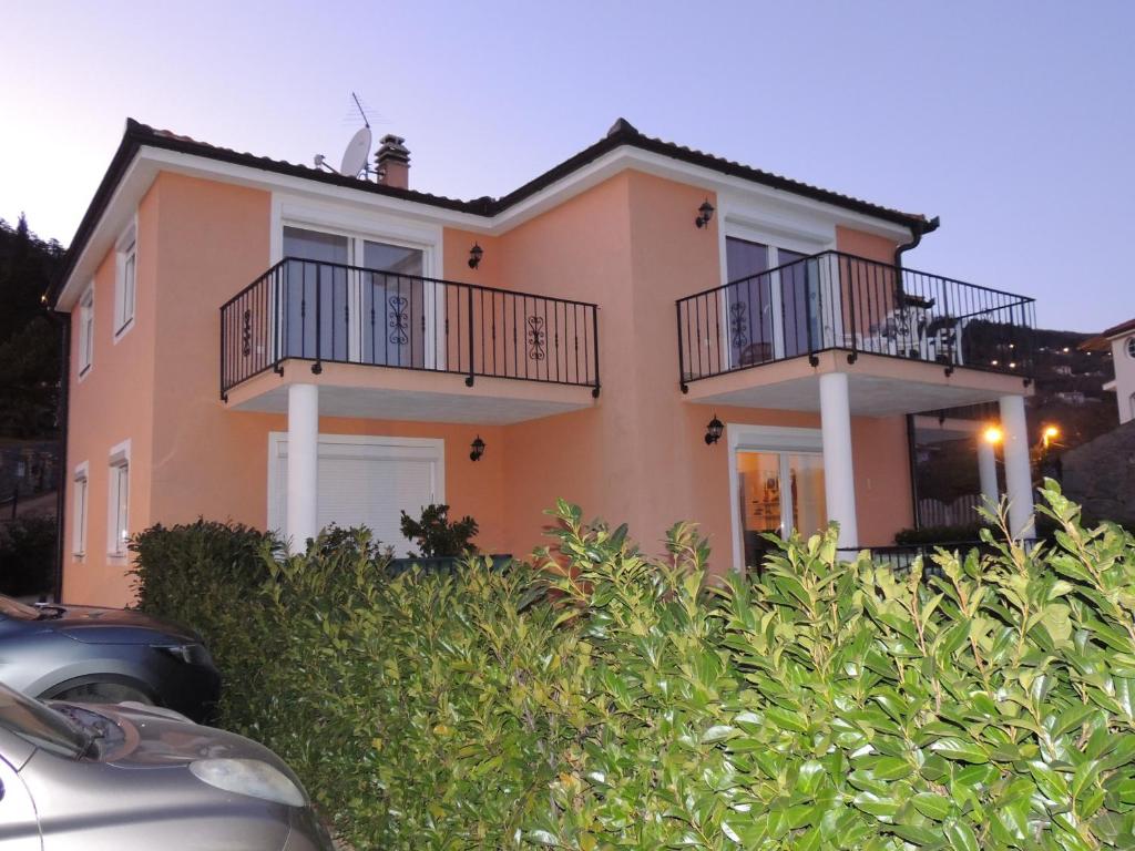 a house with two balconies on top of it at Apartment Cindy in Lovran