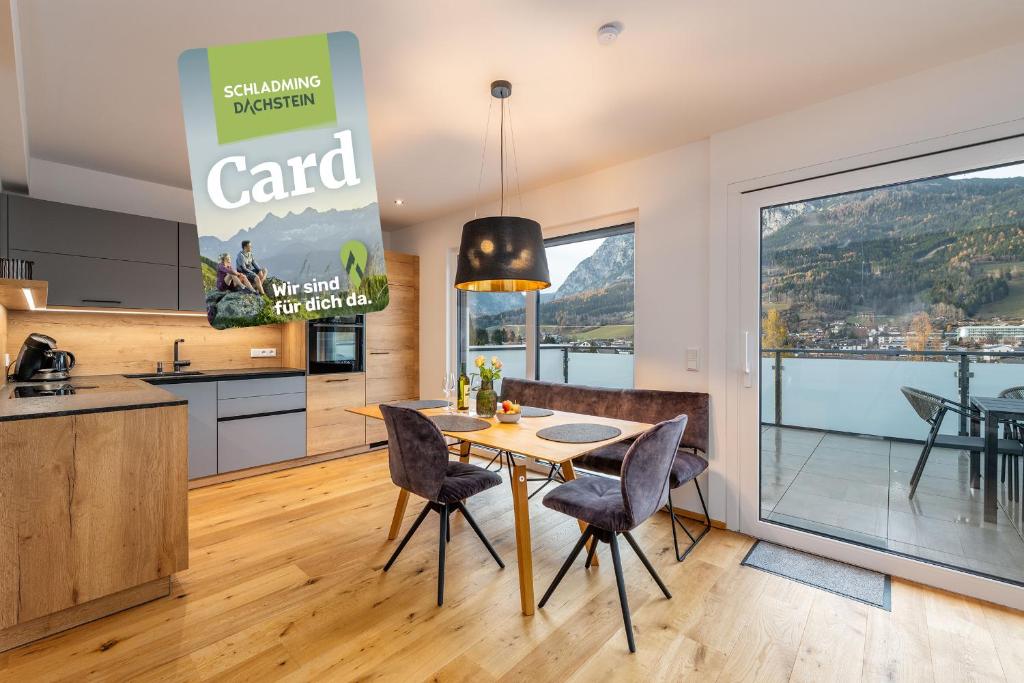 a kitchen and dining room with a table and chairs at Drei Berge Panorama Suites - by myNests in Gröbming