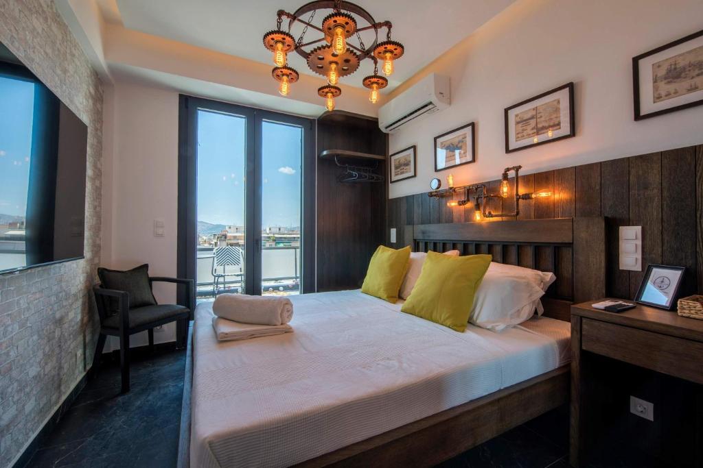 a bedroom with a large bed with a large window at Captain Stam Suites Athens - CityStudio in Athens