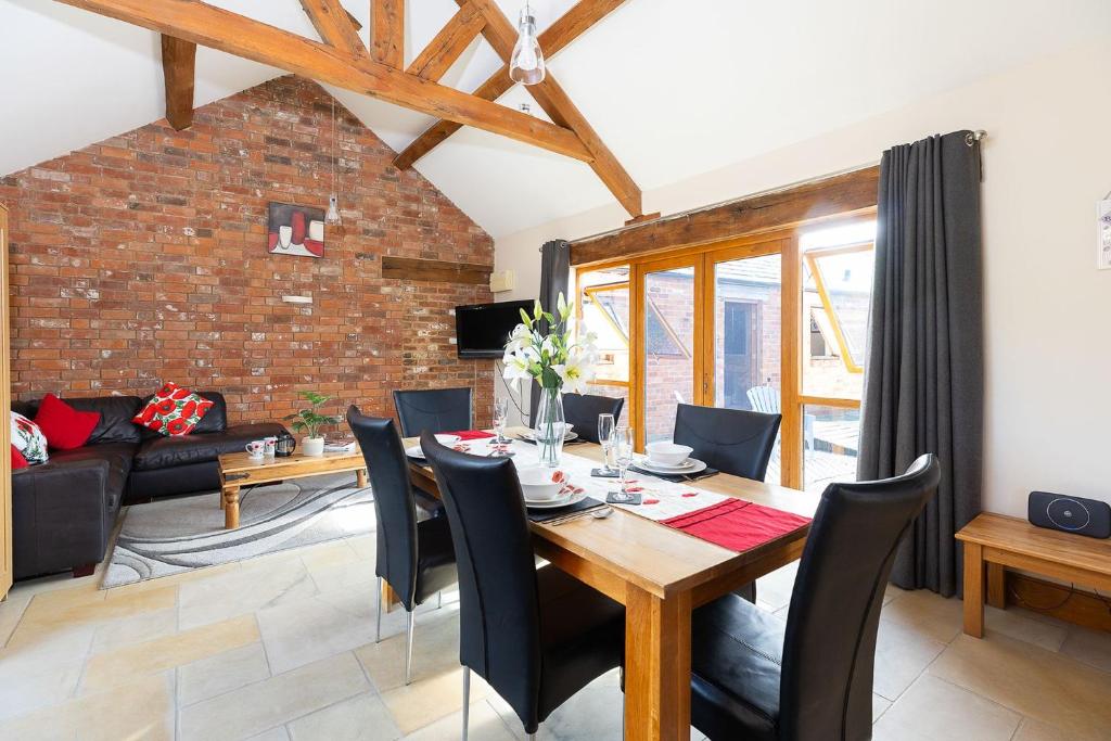 a dining room and living room with a table and chairs at Blackberry Barn in Wotton-under-Edge