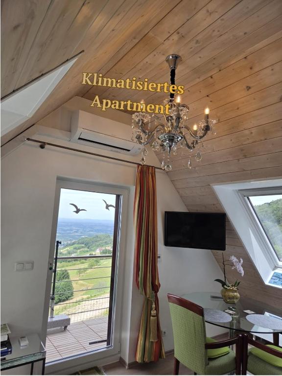 a chandelier in a room with a table and a window at Haus "Guck - ins - Tal" in Sasbachwalden