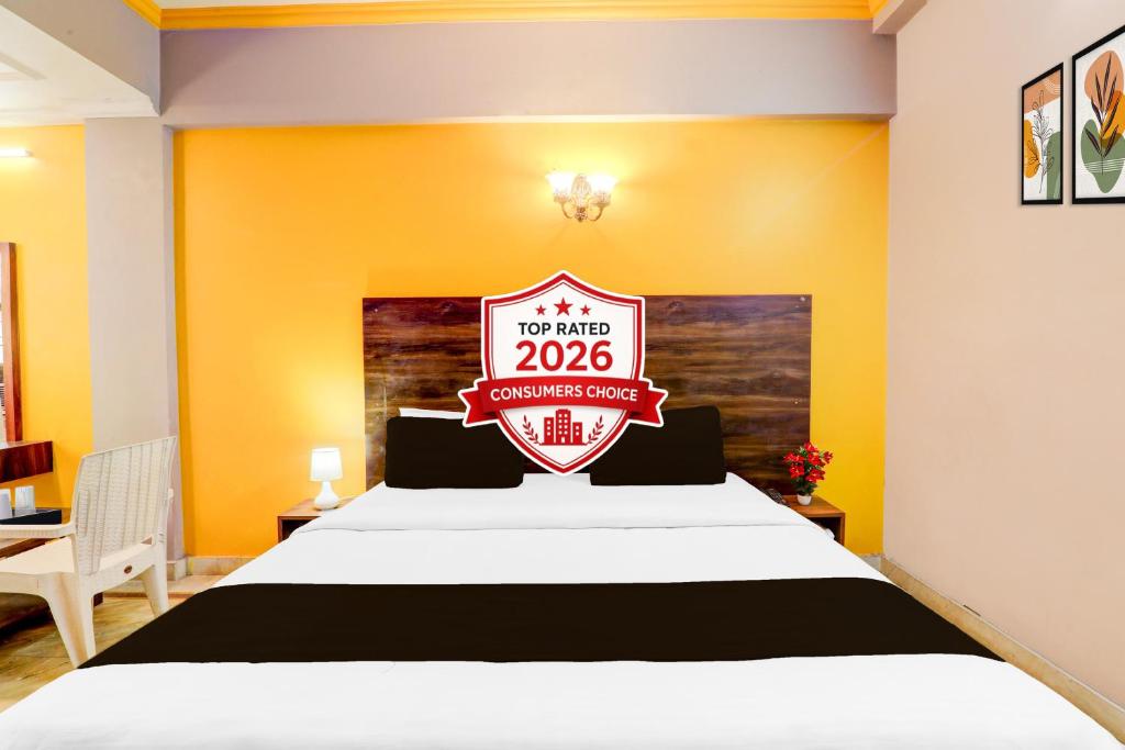 a hotel room with a bed with a sign on it at Super Hotel O Insaf Nagar Munshipuliya Formerly Vibrant in Lucknow