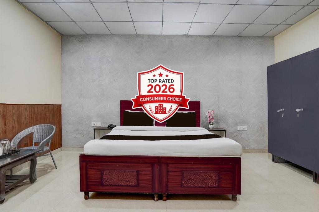 a bed in a room with a sign on it at Hotel O by OYO Sector 58 Mohali Formerly Hotel Alpha in Mohali