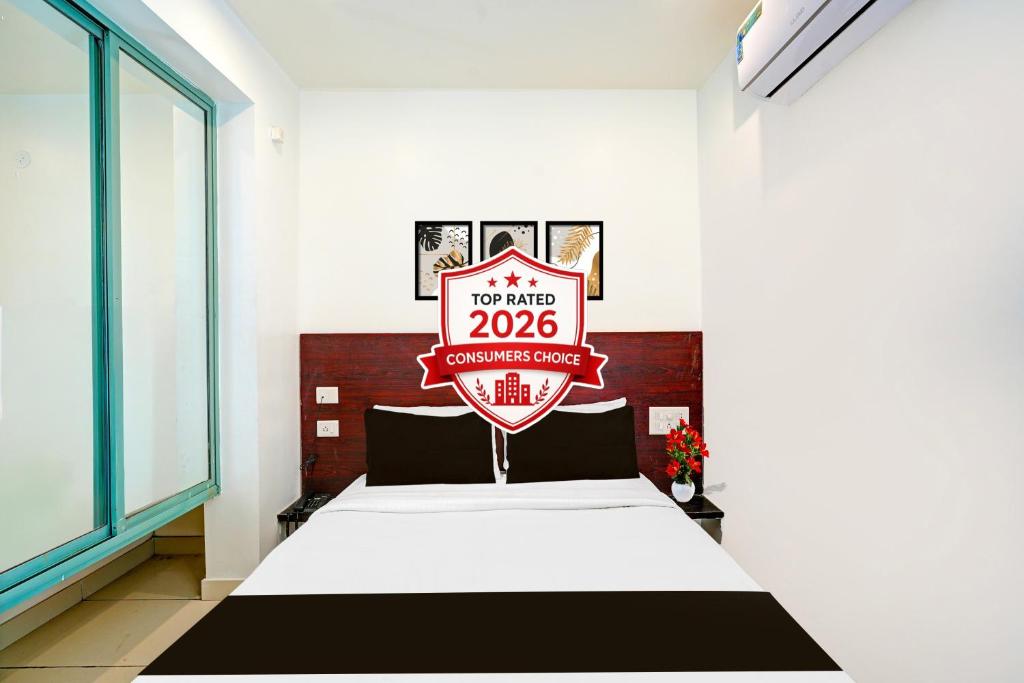 a room with a bed with a sign that reads at Super Hotel O Kaveri Road Mysore Formerly Hotel Nisarga in Mysore