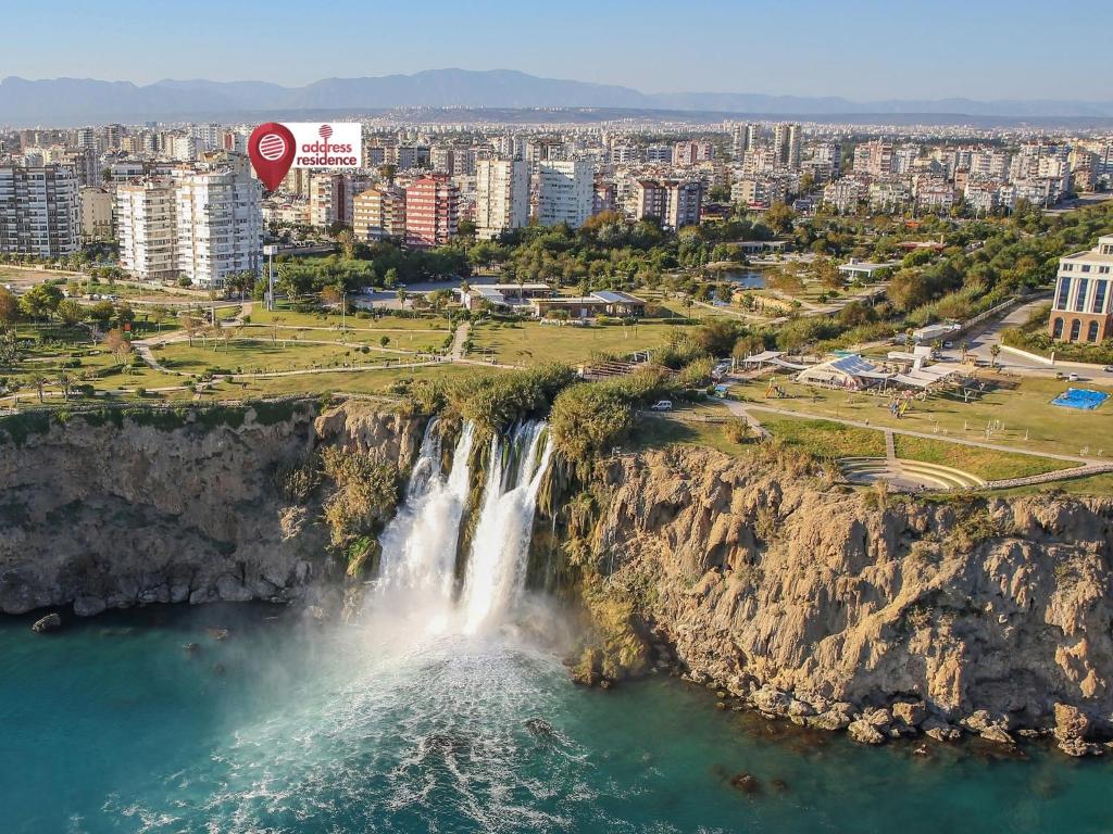 a hot air balloon flying over a waterfall at Address Residence Suite Hotel in Antalya