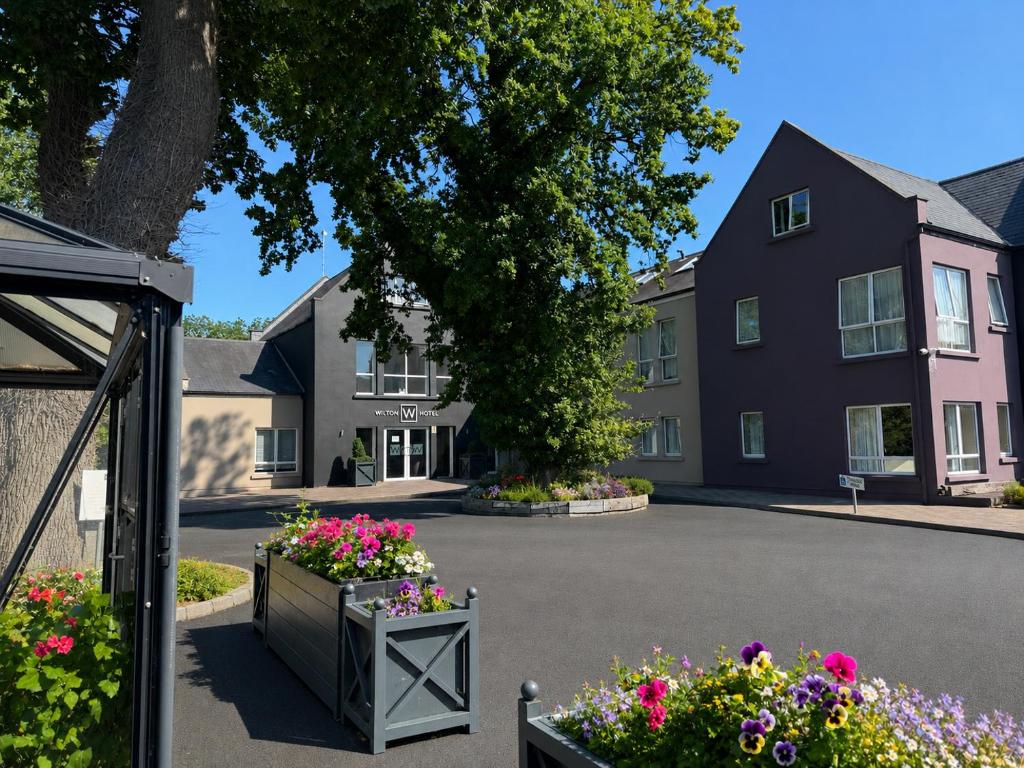 a building with flowers in front of a building at Wilton Hotel Bray in Bray