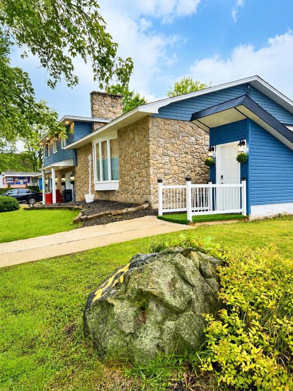 a house with a rock in front of it at Cozy 2-Bedroom Suite Near Moncton Hospital & NBCC in Moncton