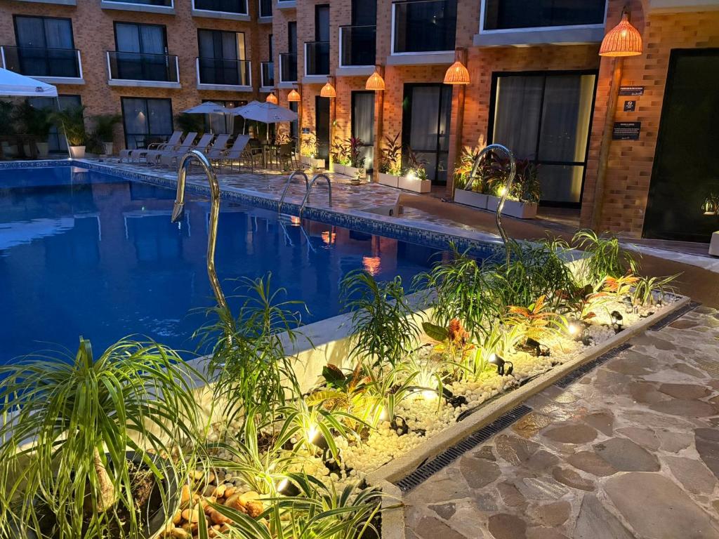 a hotel swimming pool with chairs and a building at Bessa Beach Hotel in João Pessoa