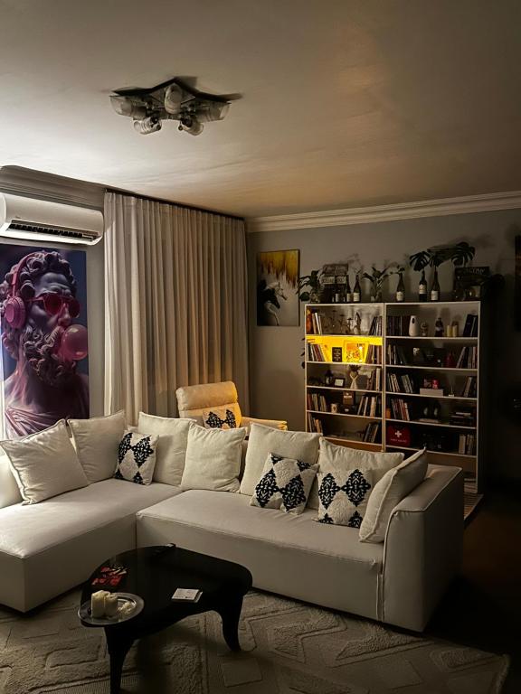 a living room with a white couch and a table at Amazing home stays 3 in Dar es Salaam