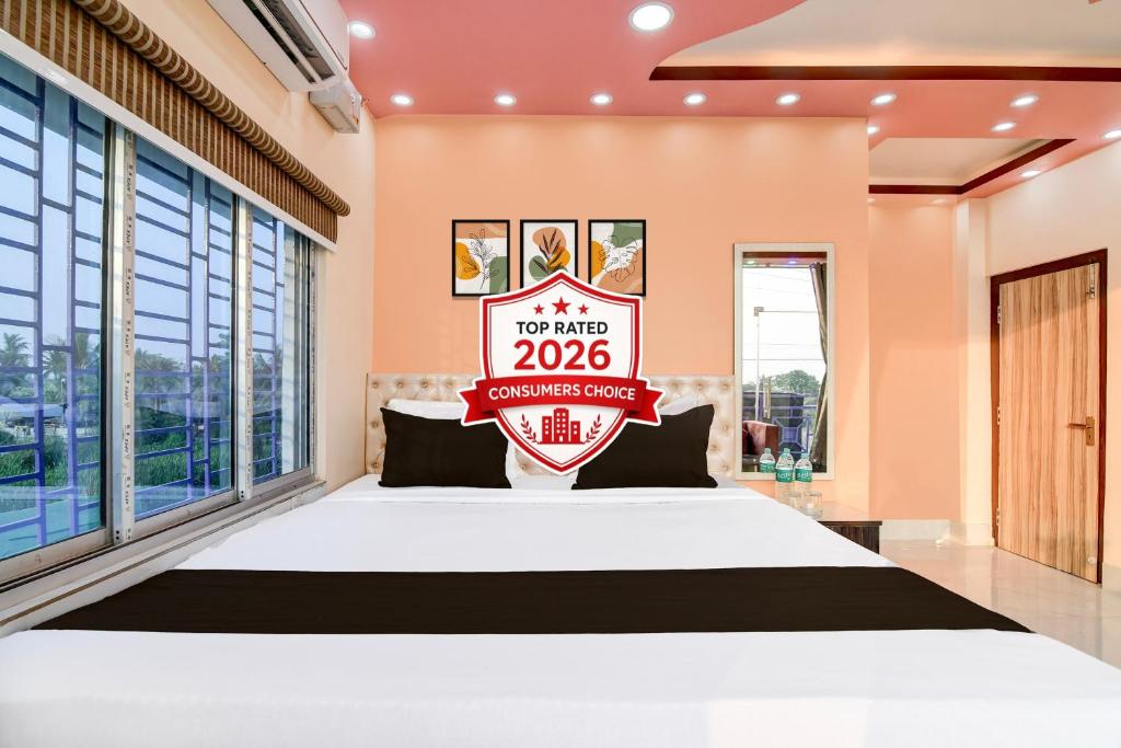 a bedroom with a bed with a sign on it at Hotel O Kakdwip in Kākdwīp