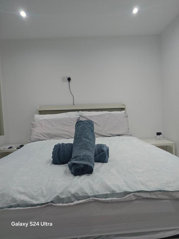 a bed with a blue towel on top of it at Best room in Birmingham