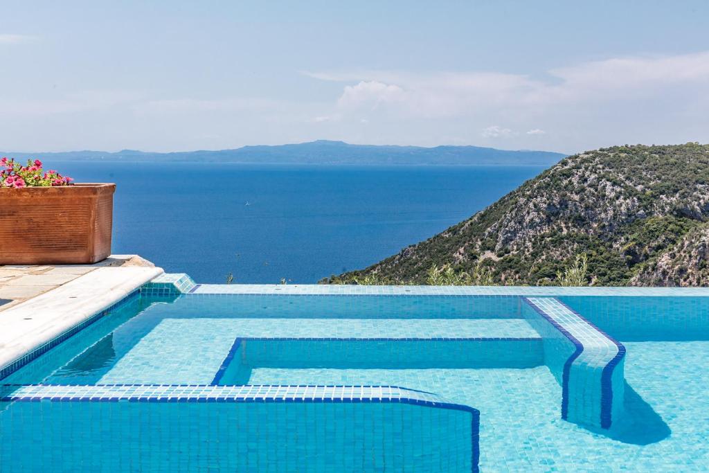 a swimming pool with a view of the ocean at Elies Houses in Agnontas