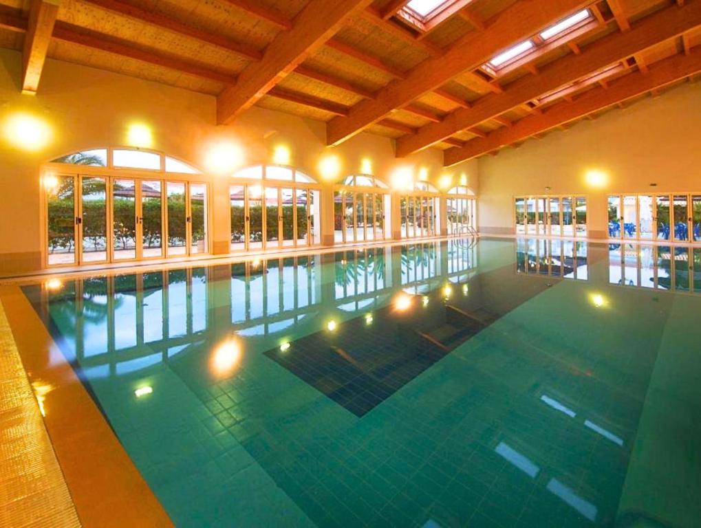 a large swimming pool with lights in a building at Apartamento Oásis Parque 3 in Portimão