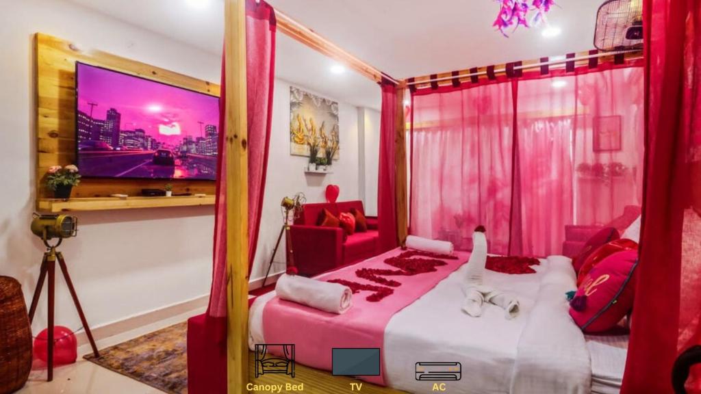 a bedroom with a large bed with pink curtains at DSR Pink Suites in Hyderabad