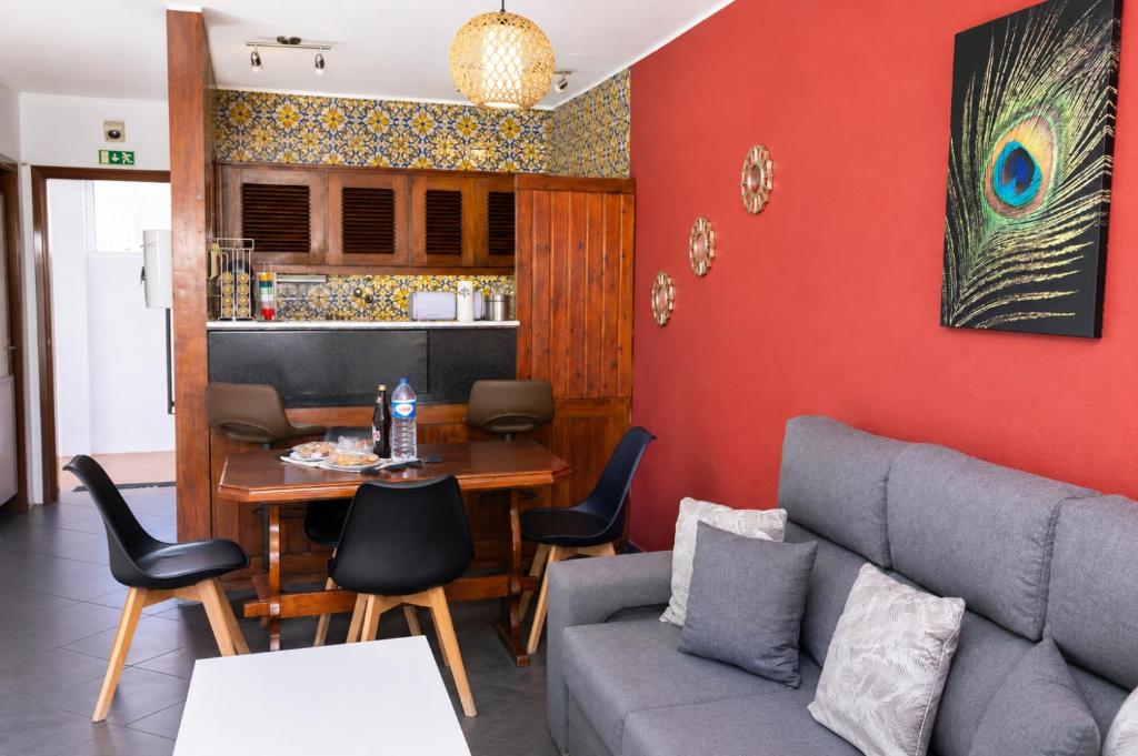 a living room with a couch and a table at Spot Matur Apartment in Machico