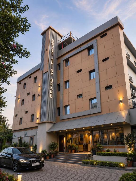 a hotel with a car parked in front of it at Hotel Shiny Grand in Guwahati
