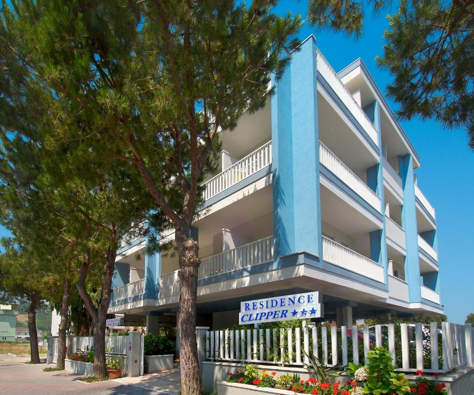 a blue building with a sign for a residence center at Residence Clipper in Giulianova