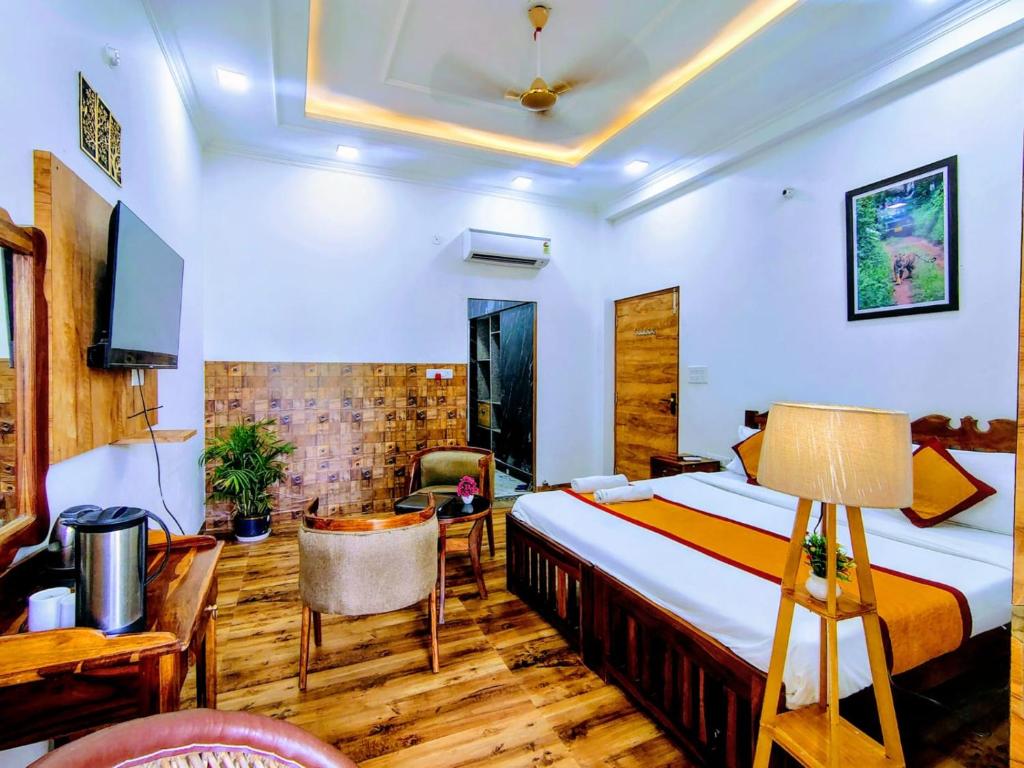 a bedroom with a bed and a desk and a tv at Ranthambore Jalsa in Sawāi Mādhopur